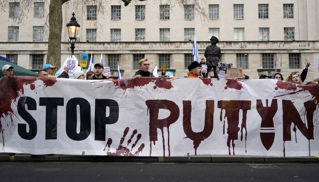 Orang-orang mengambil bagian dalam aksi solidaritas untuk mendukung Ukraina di dekat Downing Street di Whitehall di pusat kota London, Inggris, Minggu (13/3/2022). 