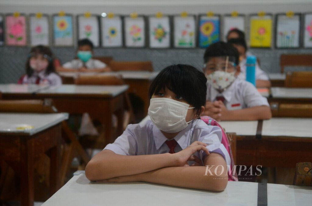 Pemakaian masker dan pembatasan kehadiran siswa sebagai bentuk penerapan protokol kesehatan untuk melakukan kelas tatap muka di SD Negeri Pekunden, Kota Semarang, Jawa Tengah, Senin (30/8/2021).