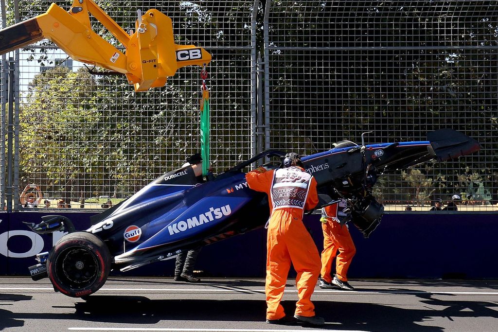 Beberapa <i>masrhal </i>memindahkan mobil pebalap tim Williams, Alexander Albon, yang mengalami tabrakan pada sesi latihan pertama F1 seri Australia di Sirkuit Albert Park, Melbourne, Australia, Jumat (22/3/2024).