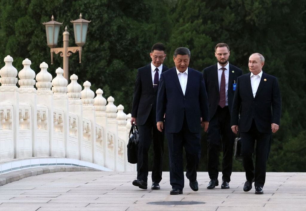 Chinese President Xi Jinping (second from left) walks with Russian President Vladimir Putin (right) in Beijing, China, Thursday (16/5/2024).