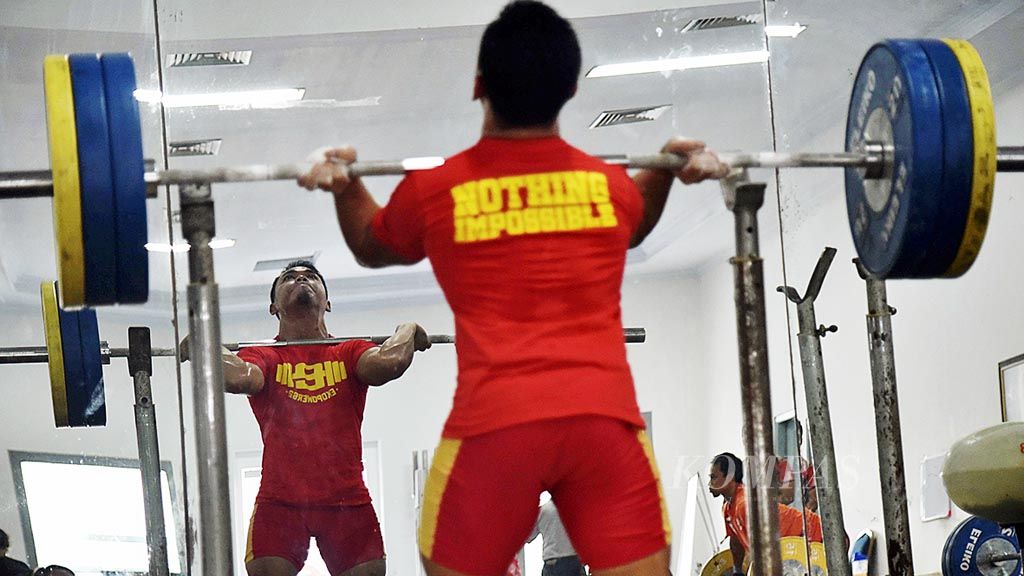 Lifter andalan Indonesia di kelas 62 kilogram, Eko Yuli Irawan, berlatih di pelatnas angkat besi nasional di Markas Komando Pasukan Marinir 2, Jakarta, Senin (19/3). Eko kembali optimistis berprestasi setelah kelas 62 kilogram kembali dilombakan pada Asian Games 2018.