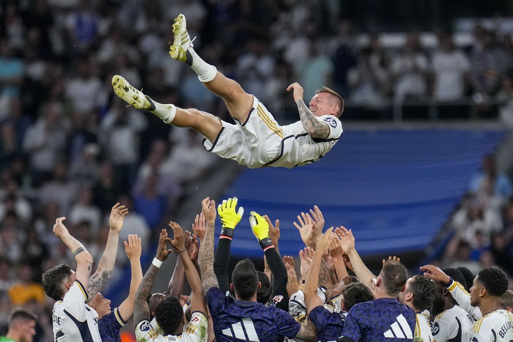 Gelandang Real Madrid, Toni Kroos, dilambungkan ke udara oleh rekan-rekannya setelah pertandingan Liga Spanyol antara Real Madrid dan Betis di Stadion Santiago Bernabeu, Madrid, Sabtu (25/5/2024). 