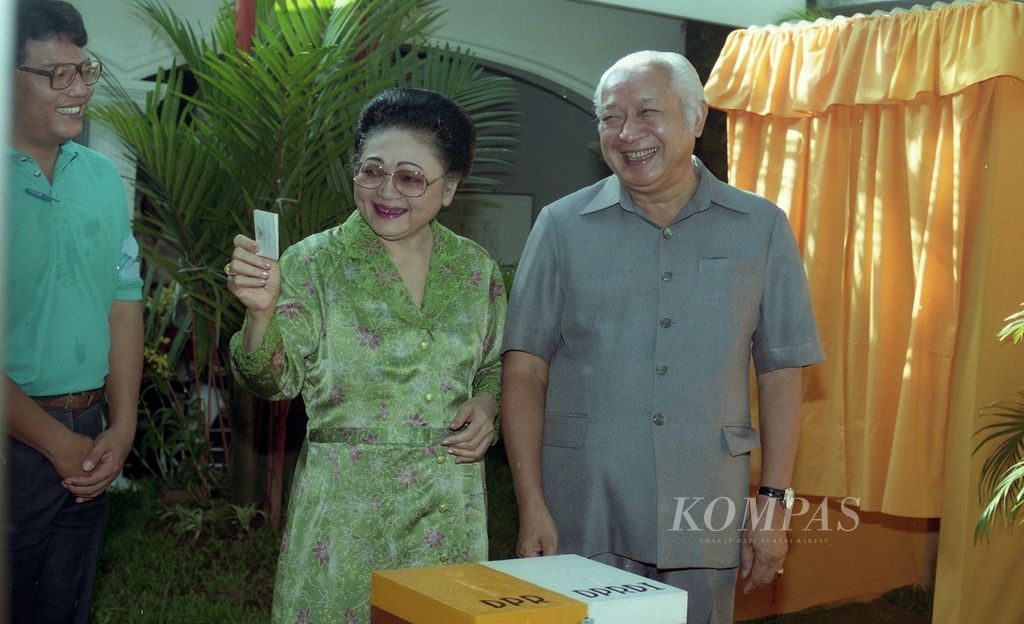Presiden Soeharto bersama Ibu Tien Soeharto tersenyum ketika memasukkan surat suara Pemilu 1992 di TPS 02 Cendana, Kelurahan Gondangdia, Kecamatan Menteng, Selasa pagi (9/6/1992).