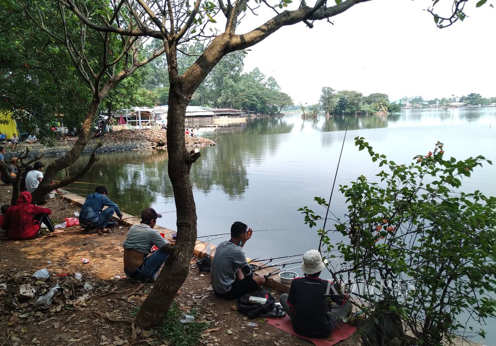 Warga mengisi waktu libur Lebaran dengan mancing di Situ Cipondoh, Kecamatan Cipondoh, Kota Tangerang, Banten, Minggu (16/5/2021). 