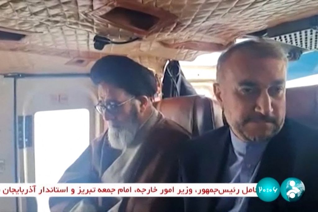 A photo from this video capture released by Iranian TV station IRINN on May 19, 2024 shows Iranian Foreign Minister Hossein Amir-Abdollahian (right) riding in a helicopter in the Jolfa area of East Azerbaijan, northwest Iran.