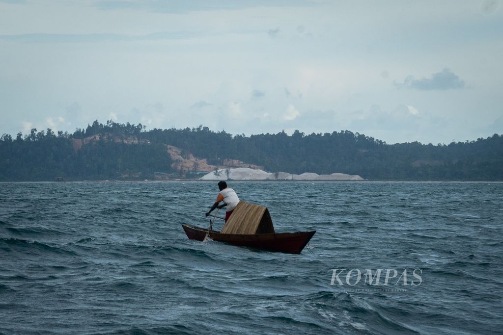 Warga suku Laut mendayung sampan di kawasan pesisir yang menjadi lokasi tambang pasir kuarsa di Desa Penaah, Kecamatan Senayang, Kabupaten Lingga, Kepulauan Riau, Kamis (21/7/2022).