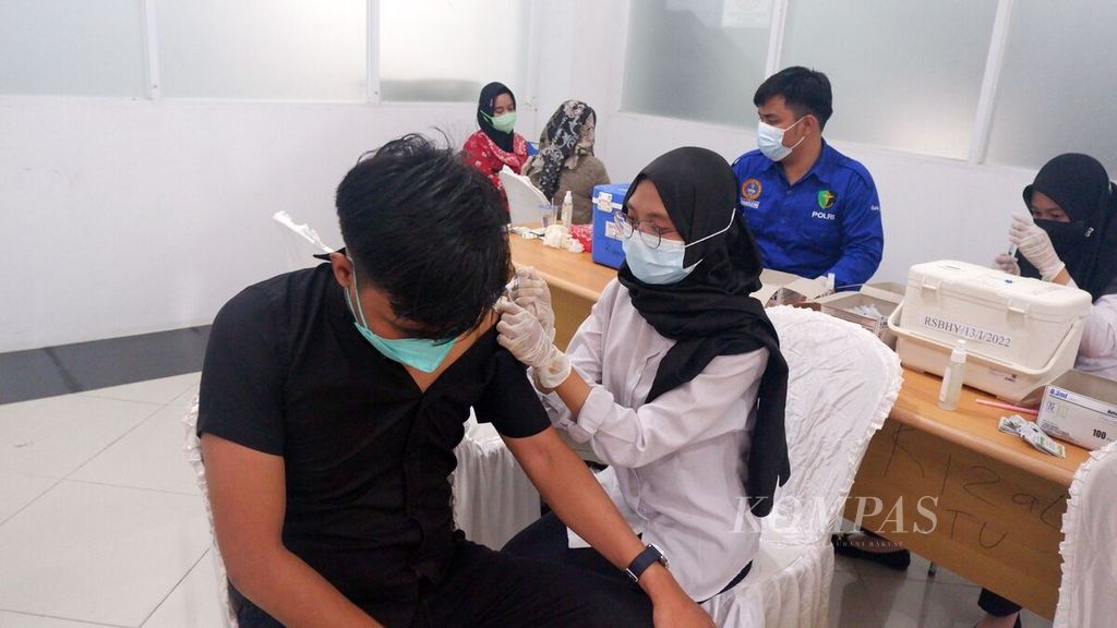 Petugas kesehatan menyuntikkan vaksin dosis ketiga (<i>booster</i>) kepada warga di Terminal Tipe A Gambut Barakat, Kabupaten Banjar, Kalimantan Selatan, Selasa (15/3/2022).