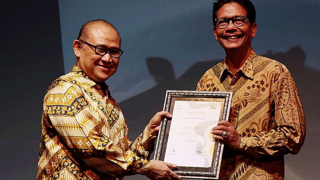 Direktur Budaya  Taman Mini Indonesia Indah (TMII) Sulistyo Tirtokusumo (kiri) menyerahkan tanda penghargaan kepada untuk seniman ketoprak Muhadi Hartono, Sabtu (17/6) malam, di Anjungan Jawa Timur, TMII, Jakarta.