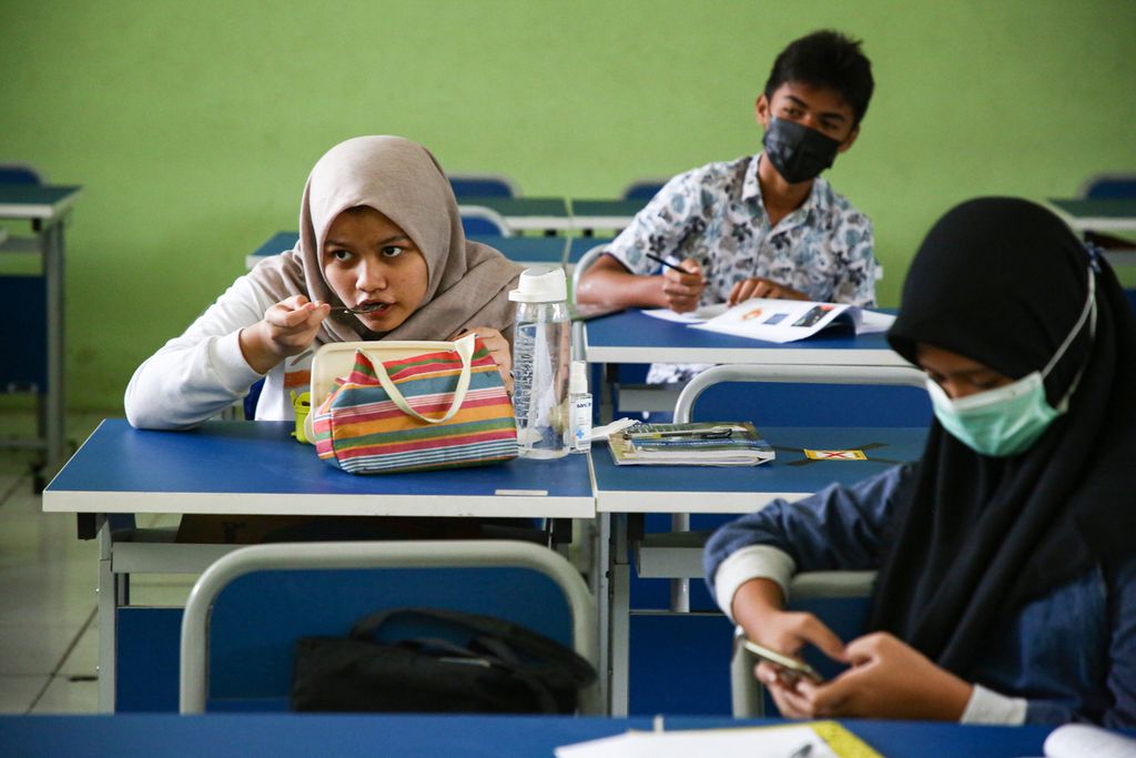 Siswa menikmati bekalnya saat jam istirahat pada hari pertama pelaksanaan sekolah tatap muka di SMP Negeri 2 Kota Bekasi, Jawa Barat, Senin (22/3/2021).  