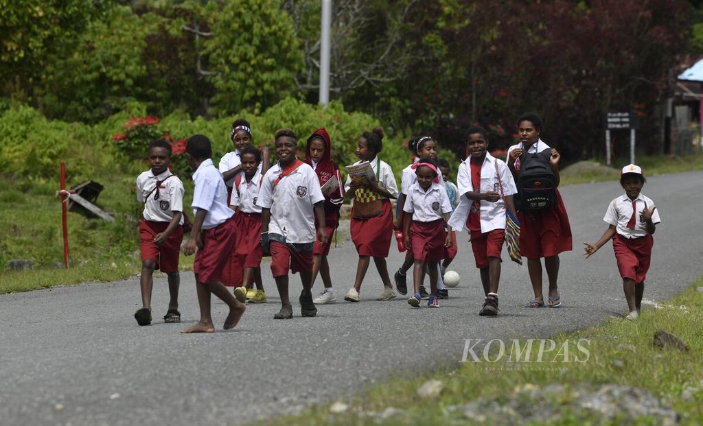 Sejumlah siswa sekolah dasar berjalan kaki bersama saat pulang sekolah di Kampung Indabri, Pegunungan Arfak, Papua Barat, awal 2021.
