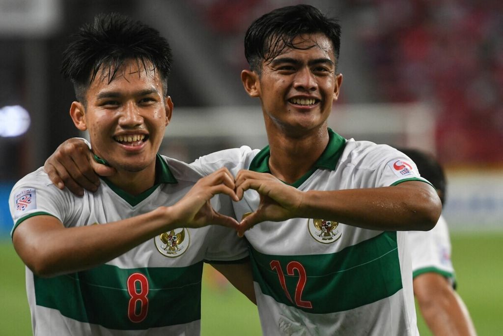 Dua pemain muda Indonesia, Witan Sulaeman (kiri) dan Pratama Arhan Alif Rifai, merayakan gol yang dicetak Witan ke gawang Singapura pada laga pertama semifinal Piala AFF 2020 di Stadion Nasional Singapura, 22 Desember 2021.