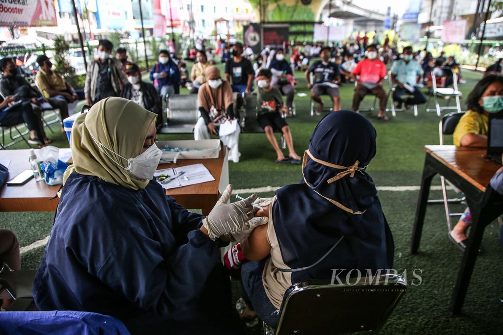 Warga mengikuti vaksinasi Covid-19 dosis ketiga atau <i>booster</i> yang diadakan Polsek Ciputat Timur di bawah jalan layang Ciputat, Tangerang Selatan, Banten, Sabtu (2/4/2022). Vaksinasi dosis ketiga diserbu warga setelah pemerintah mengumumkan sebagai salah satu syarat mudik Lebaran tahun ini. Jelang Ramadhan, Polri menargetkan vaksinasi <i>booster</i> lebih dari 1 juta dosis. 