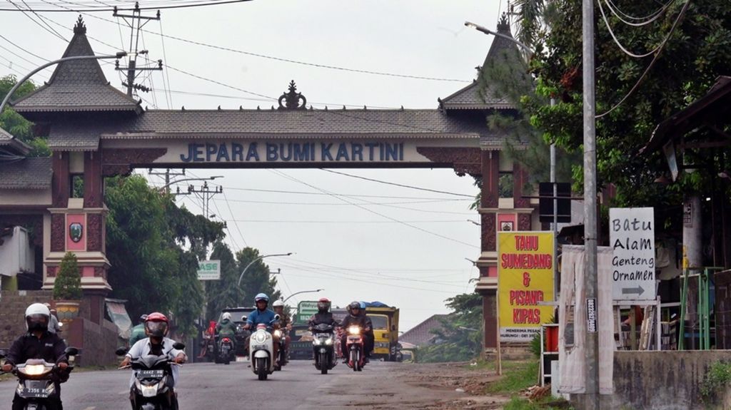 Sejumlah kendaraan melewati salah satu gapura Kabupaten Jepara di Kecamatan Tahunan, Jepara, Jawa Tengah, Jumat (12/11/2021). Sebagai kota ukir, banyak showroom produk mebel serta ukir di kanan dan kiri jalan utama di Jepara.