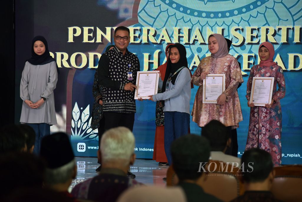 Kepala Bank Indonesia Sumatera Selatan Ricky Perdana Gozali memberikan sertifikat halal kepada pelaku UMKM dalam Syariah Festival Sriwijaya 2024 di Palembang Indah Mall, Sumatera Selatan, Kamis (28/3/2024).