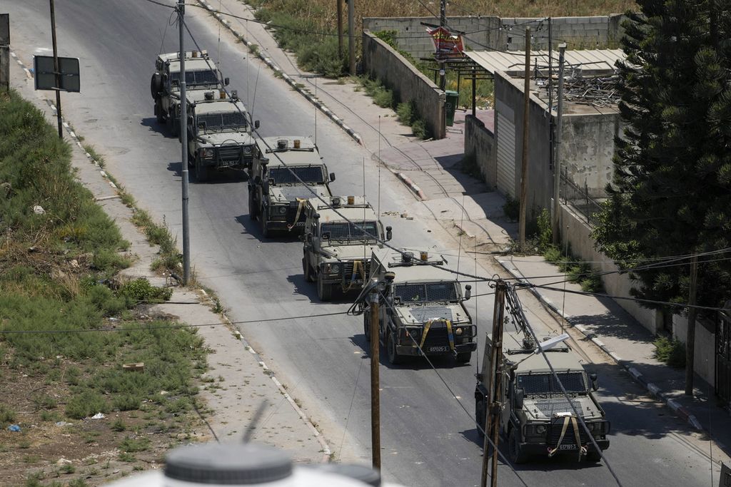 Konvoi kendaraan militer Pasukan Pertahanan Israel (IDF) terlihat berjalan menuju ke kamp Jenin di Jenin, Tepi Barat, Senin (3/7/2023). Sebanyak 10.000 anggota pasukan cadangan Israel dilaporkan menolak bertugas. Penolakan itu bagian dari protes pada upaya perombakan sistem peradilan Israel.