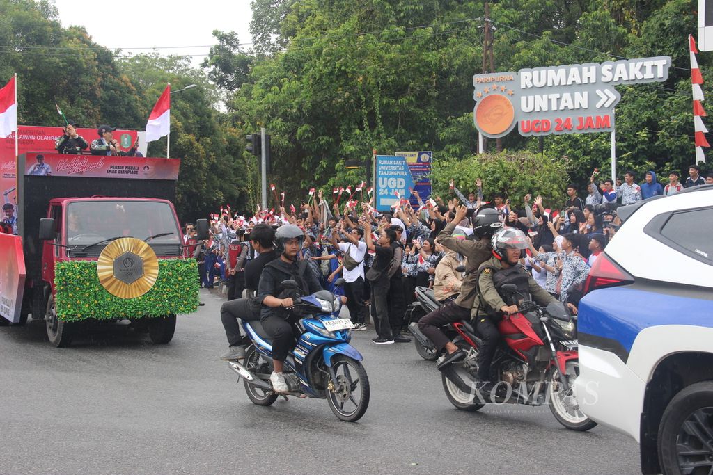 Warga, pelajar, dan mahasiswa menyapa Veddriq Leonardo, peraih medali emas panjat tebing di Olimpiade Paris 2024, di sekitar Bundaran Digulis, Kota Pontianak, Kalimantan Barat, Rabu (21/8/2024).