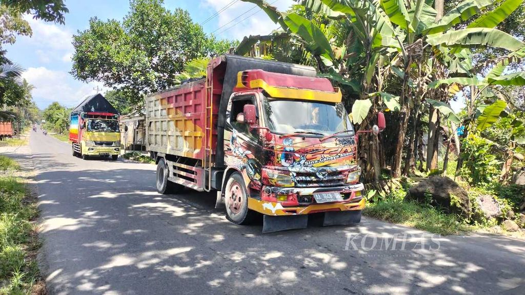 Sejumlah truk pengangkut pasir dan batu hasil tambang dari lereng Gunung Merapi  melintasi jalan di Kecamatan Srumbung, Kabupaten Magelang, Jawa Tengah, Minggu (12/3/2023).