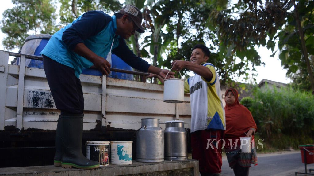 Warga menjual susu dari sapi perah kepada petugas koperasi unit desa di Dusun Watesari, Desa Sruni, Musuk, Boyolali, Jawa Tengah, Rabu (12/6/2019). Setelah disetor ke KUD setempat, susu yang terkumpul kemudian dipasok ke industri minuman susu. Harga jual susu dari peternak ke KUD saat ini Rp 5.000 per liter.
