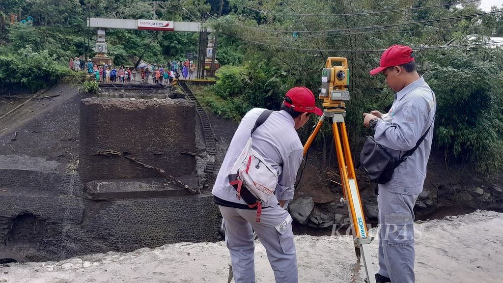 Petugas Balai Besar Pelaksanaan Jalan Nasional Jawa Timur-Bali melakukan survei di lokasi Jembatan Kali Glidik II yang putus diterjang banjir lahar hujan Semeru, di perbatasan Kabupaten Lumajang-Malang, Sabtu (8/7/2023).