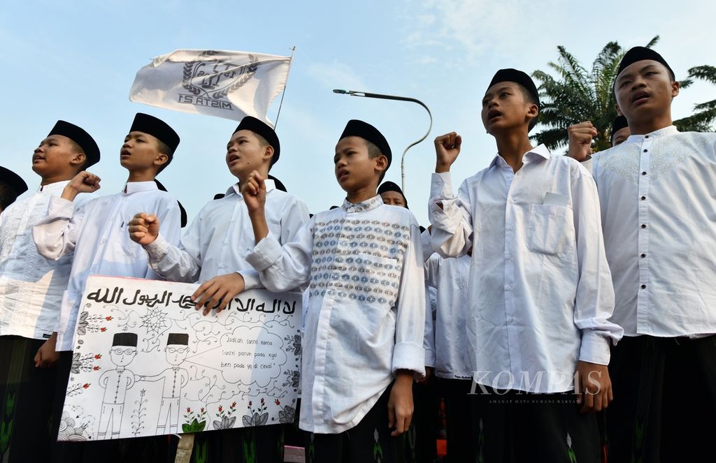 Para santriwan menyanyikan Mars Hari Santri saat mengikuti Kirab Santri dan Kirab Pemilu 2024 di Taman Elektrik, Kota Tangerang, Banten, Minggu (12/11/2023).