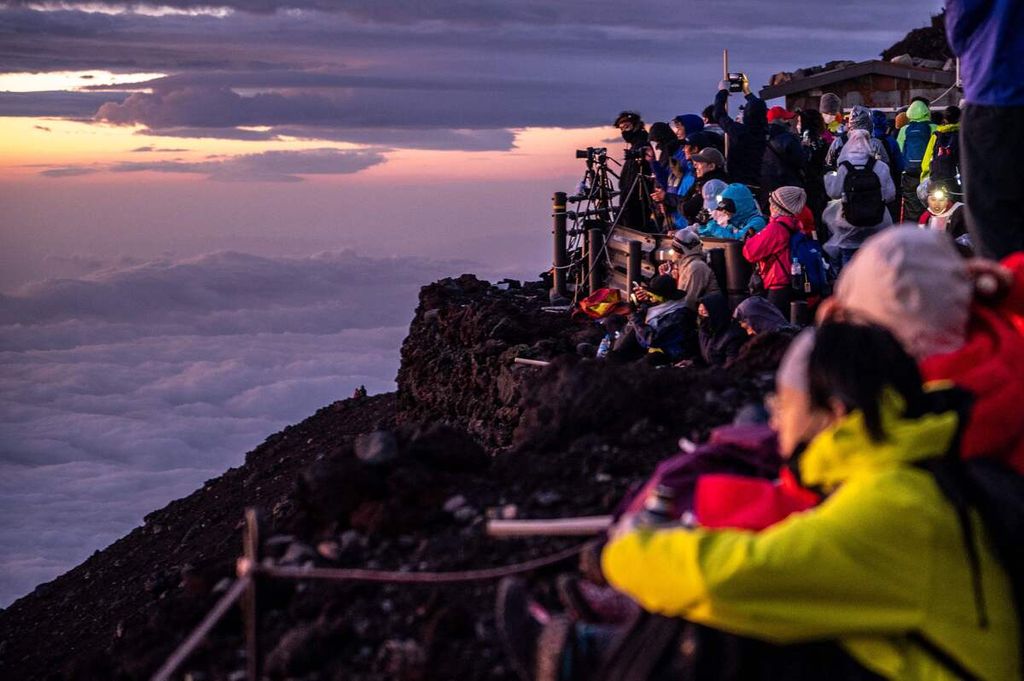 Para wisatawan menyaksikan momen matahari terbit dari puncak Gunung Fuji, sekitar 70 kilometer dari Tokyo, Jepang, 15 Agustus 2022 dini hari. 