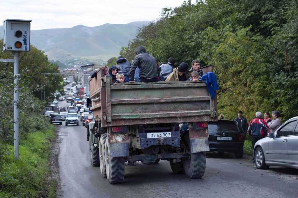 Armenian ethnic residents from Nagorno-Karabakh are seen on a truck en route to seek refuge in Armenia, as pictured on their journey towards Goris, Syunik region, Armenia, on Tuesday (26/9/2023).