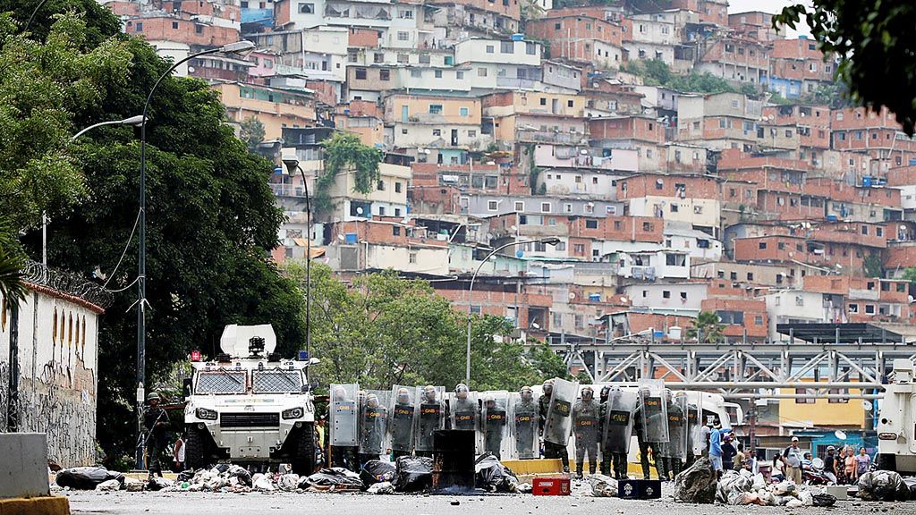 Garda Nasional Venezuela melindungi diri dengan perisai  saat mengawal unjuk rasa massa penentang pemerintahan Presiden Nicolas Maduro di Caracas, Venezuela, Selasa (2/5). 