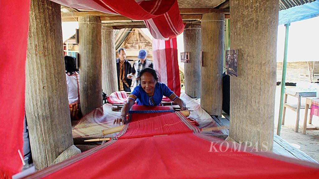 Rangge (55) menenun kain khas Mamasa yang bercirikan warna merah menyala di Desa Balla Satanatean, Kecamatan Balla, Kabupaten Mamasa, Sulawesi Barat, Kamis (22/3/2018).
