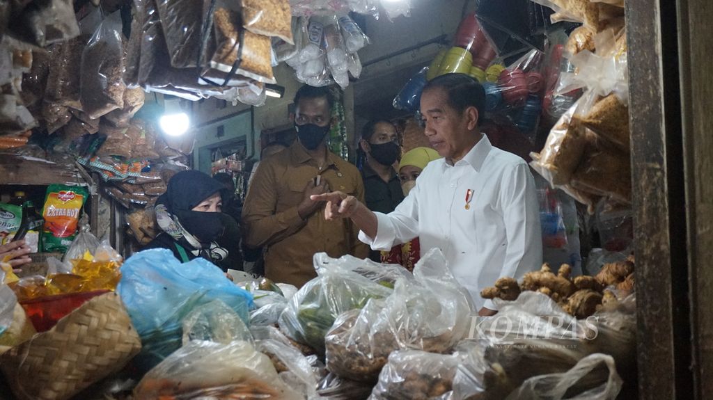Presiden Joko Widodo di sela kunjungan ke Surabaya, Jawa Timur, Sabtu (18/2/2023), mendatangi Pasar Wonokromo untuk menyapa pedagang, seperti terlihat di kios milik Sulastri (61).