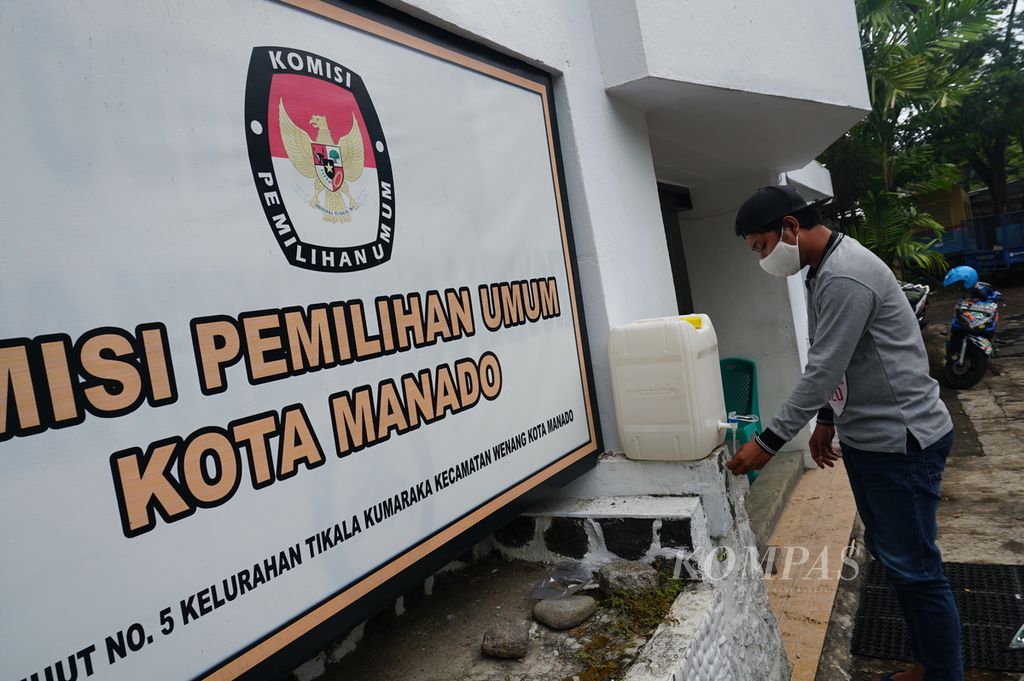 Pegawai Komisi Pemilihan Umum (KPU) Manado mencuci tangan sebelum memasuki kantornya di bilangan Tikala, Wenang, Manado, Sulut, Rabu (1/7/2020). KPU Manado menggunakan anggaran Rp 41 miliar yang telah diajukan untuk penyelenggaraan Pilkada 2020 untuk mengadakan fasilitas penunjang protokol kesehatan demi mencegah penularan Covid-19.