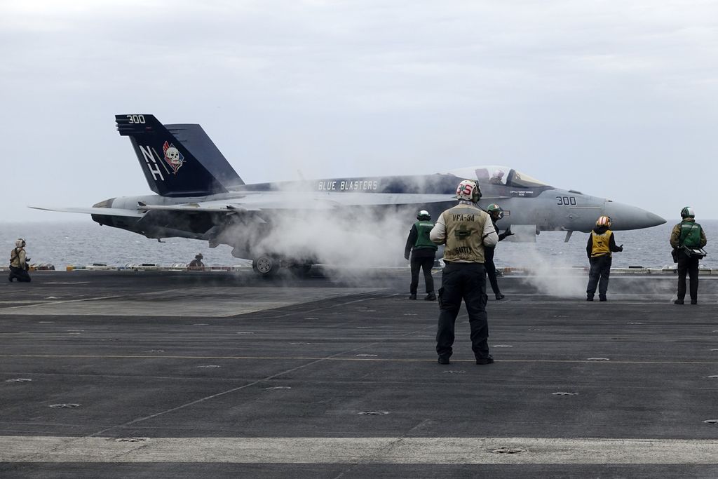 An F-18E fighter jet took off from the US aircraft carrier USS Theodore Roosevelt during joint exercises with Japan and South Korea in the East China Sea on April 11, 2024.