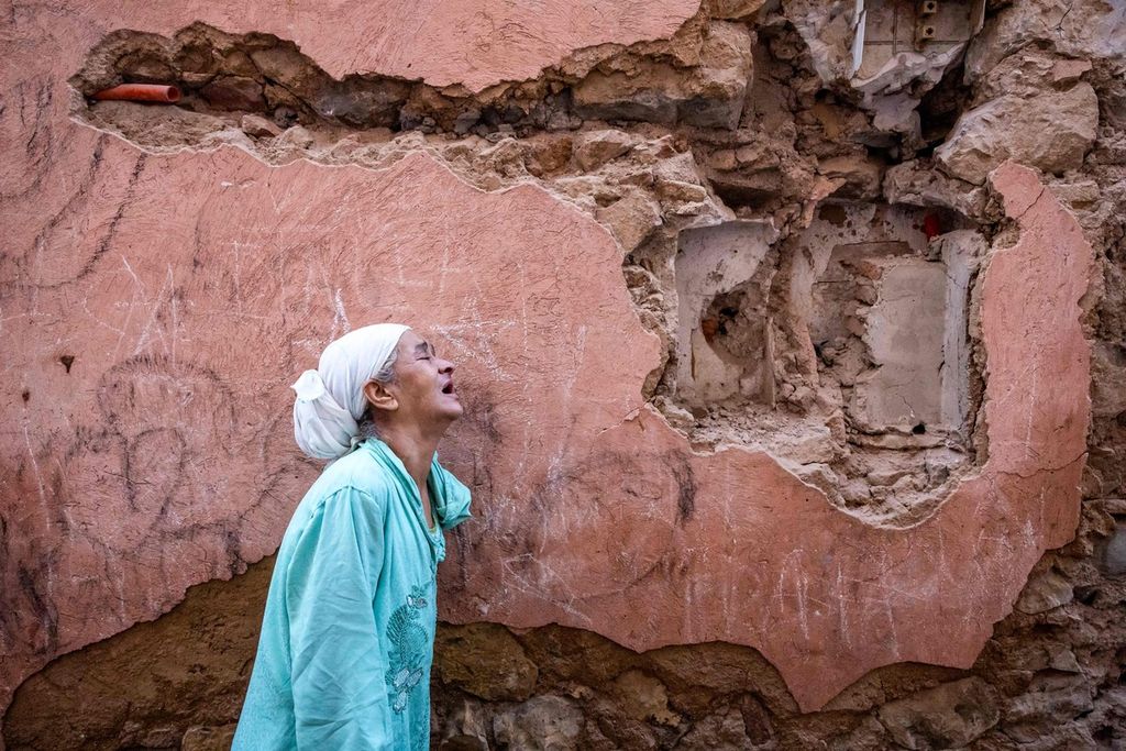 Seorang perempuan berduka di depan puing-puing rumahnya yang rusak akibat gempa di kota tua Marrakesh, Maroko, 9 September 2023. 