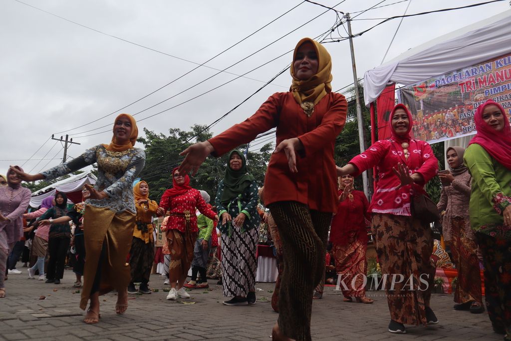 Gadis-gadis berkebaya dan para ibu bersemangat menari memeriahkan Festival Hari Pahlawan. 