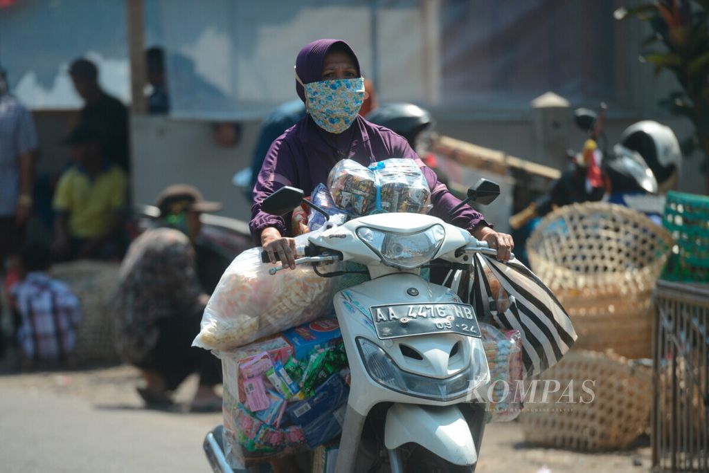 Warga membawa berbagai macam barang yang akan mengisi warung mereka di Pasar Pucang, Kecamatan Secang, Kabupaten Magelang, Jawa Tengah, Senin (24/8/2020). Modal usaha kecil yang didapat dari lembaga perbankan menjadi bagian pengembangan perekonomian kecil. 