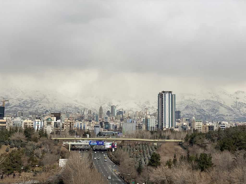  Kota Teheran, ibu kota Iran, dilihat dari Jembatan Tabiat, 11 Februari 2023, dengan pemandangan pegunungan bersalju di kejauhan. 