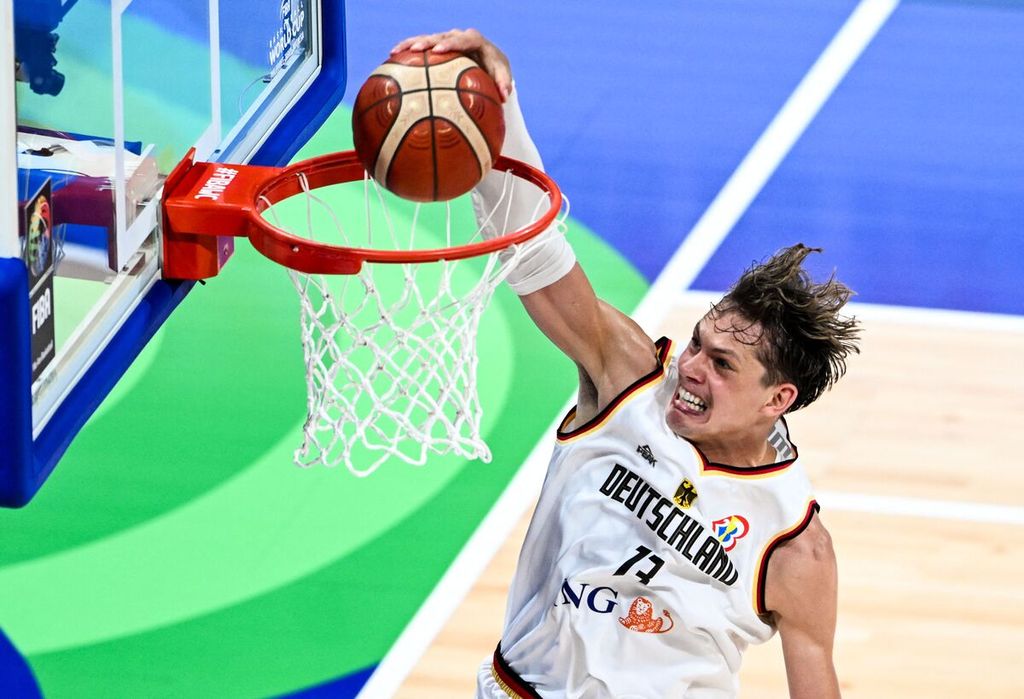 Pemain Jerman, Moritz Wagner, melakukan <i>dunks </i>ke keranjang Latvia pada laga babak perempat final Piala Dunia FIBA 2023 di Manila, Filipina, Rabu (6/9/2023). Jerman menang tipis, 81-79.
