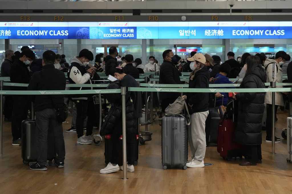 Penumpang mengantre untuk naik pesawat ke China di Bandara Internasional Incheon di Incheon, Korea Selatan, Selasa, 10 Januari 2023. 