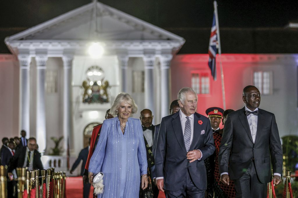 Raja Inggris, Raja Charles III (tengah) berjalan bersama Ratu Camilla (kiri) dan Presiden Kenya WIlliam Ruto (kanan) jelang makan malam kenegaraan yang diselenggarakan Ruto di Nairobi, Kenya, Selasa (31/10/2023). 