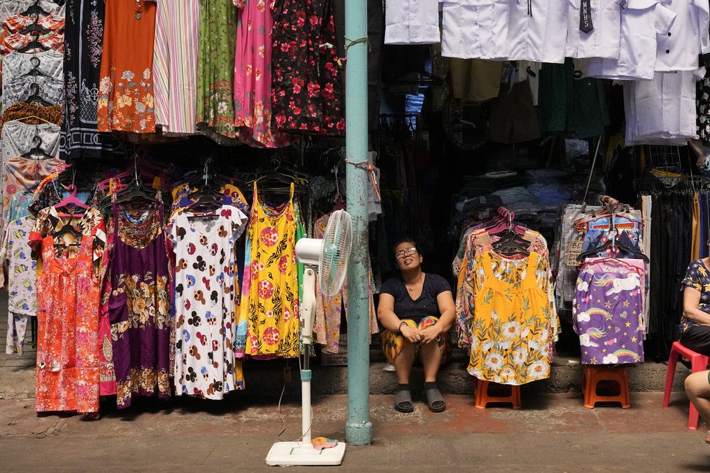 Pedagang di Marikina, Filipina, berteduh di kiosnya di tengah suhu panas pada Rabu (24/4/2024).