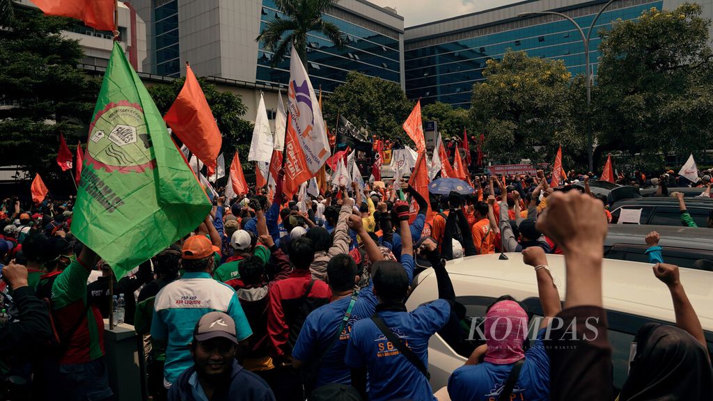 Ribuan buruh yang tergabung dalam Konfederasi Serikat Pekerja Indonesia meneriakkan yel-yel dalam unjuk rasa di Kantor Kementerian Ketenagakerjaan di Jalan Gatot Subroto, Kuningan, Jakarta Selatan, Rabu (16/2/2022). Mereka menuntut pencabutan Peraturan Menteri Ketenagakerjaan (Permenaker) Nomor 2 Tahun 2022 tentang Tata Cara dan Persyaratan Pembayaran Manfaat Jaminan Hari Tua. Kalangan buruh menolak kebijakan pemerintah mengembalikan program Jaminan Hari Tua ke fungsi awalnya sebagai tabungan masa tua. Pasalnya, dalam situasi pandemi, banyak kebutuhan mendesak dan segera. 