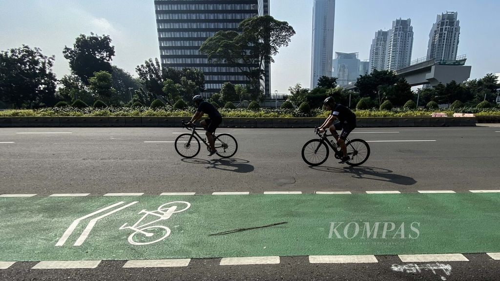 Warga bersepeda di Jalan Sudirman, Jakarta, menjelang berakhirnya masa pemberlakuan pembatasan kegiatan masyarakat (PPKM) Level 4, Minggu (1/8/2021). 