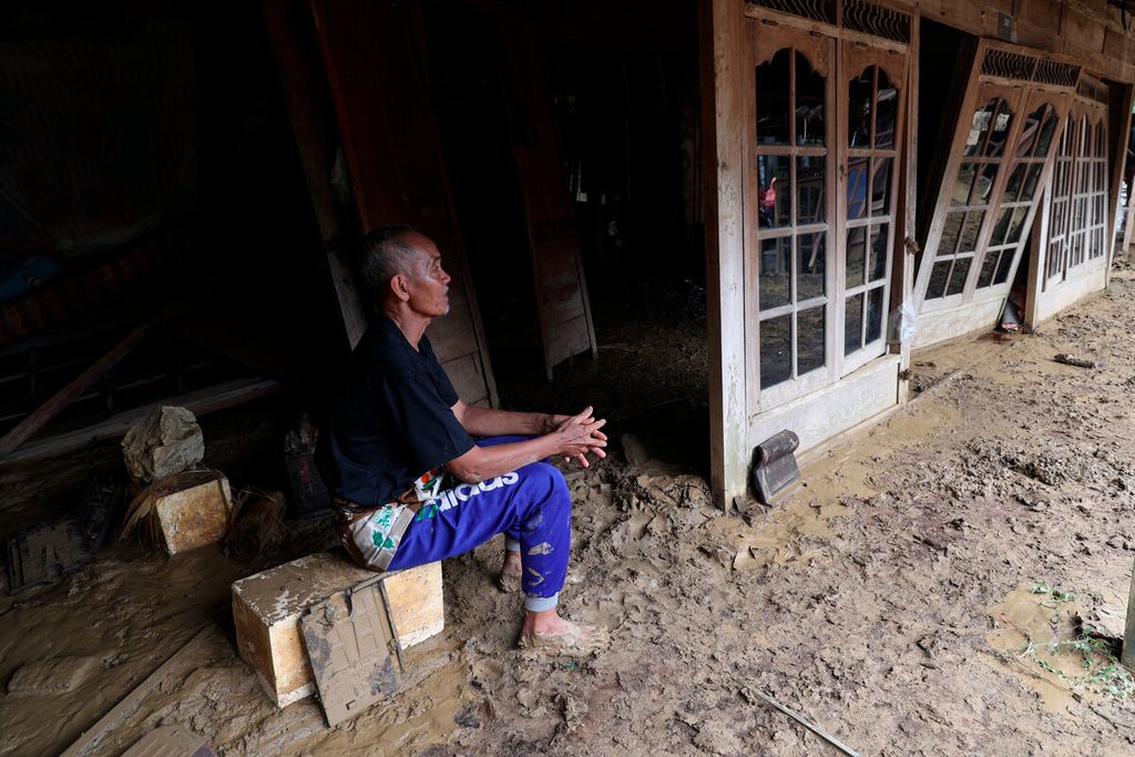 Warga di depan rumahnya yang hancur setelah banjir bandang menerjang Desa Sinomwidodo, Kecamatan Tambakromo, Kabupaten Pati, Jawa Tengah, Kamis (1/12/2022).