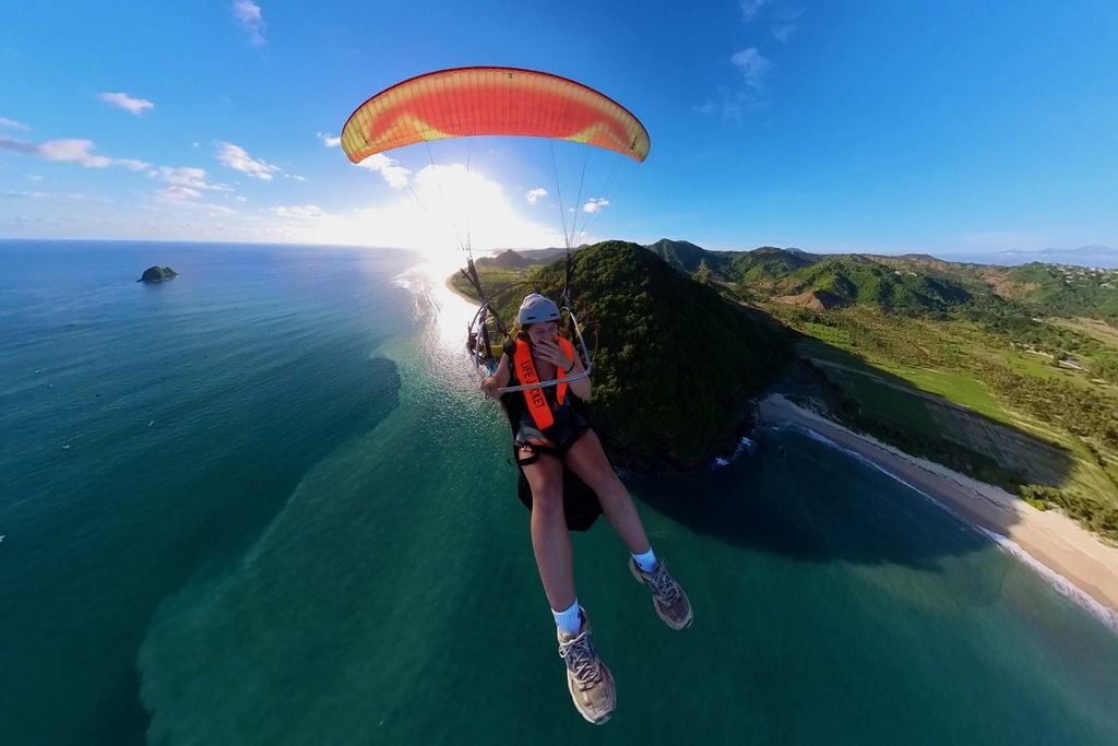 Wisatawan menikmati paramotor di kawasan Sky Lancing Lombok Paragliding, Desember 2023.