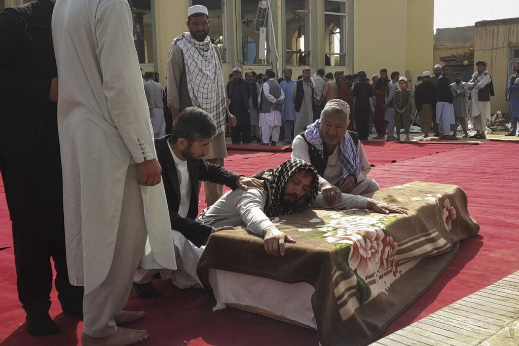 Anggota keluarga dan warga berkabung atas jatuhnya korban jiwa akibat serangan bunuh diri di sebuah masjid di Kunduz, Afghanistan utara,  9 Oktober 2021.  Serangan itu menyasar kelompok Syiah.