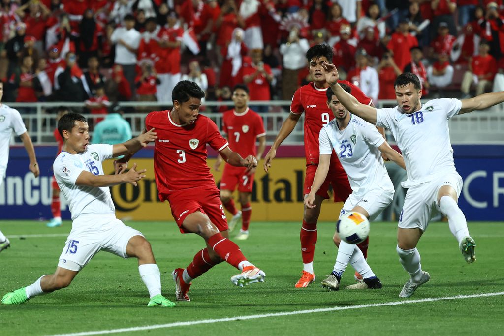 Bek Indonesia Muhammad Ferarri (kiri) dijaga gelandang Uzbekistan Umarali Rakhmonaliev saat mencoba mencetak gol pada pertandingan semifinal Piala Asia U-23 Qatar 2024 antara Indonesia dan Uzbekistan di Stadion Abdullah Bin Khalifa di Doha, Senin (29/4/2024) malam. 