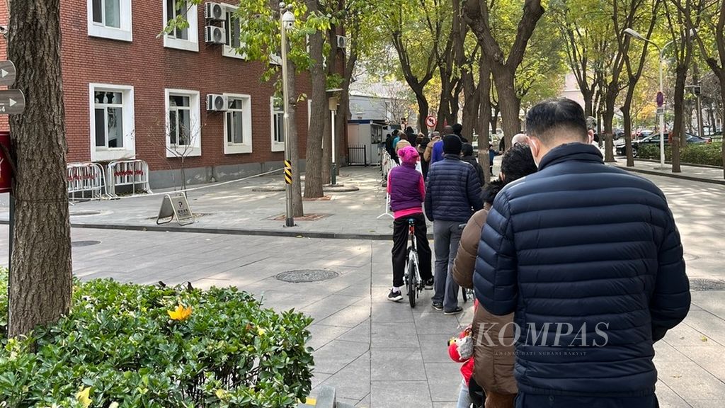Antrean panjang warga untuk menjalani tes swab Covid-19 terlihat di salah satu kompleks apartemen di Distrik Chaoyang, Beijing, China, Selasa (22/11/2022). 