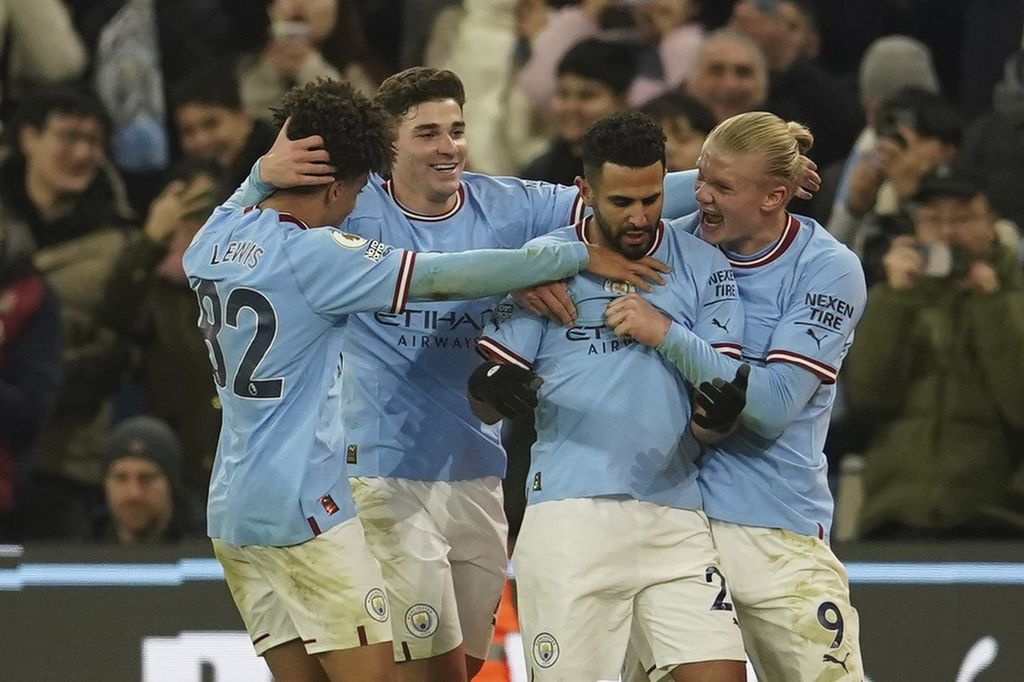 Manchester City's Riyad Mahrez, second right, celebrates with his teammates after scoring his side's third goal during the English Premier League soccer match between Manchester City and Tottenham Hotspur at the Etihad Stadium in Manchester, England, Thursday, Jan. 19, 2023. City is the top club in the Football Money League or the highest revenue for the 2021-2022 season according to Deloitte.