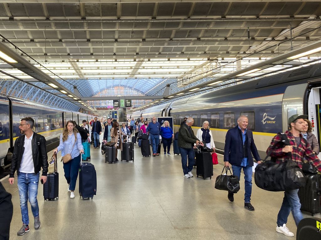 People at St Pancras international train station, London, England, board the Eurostar high-speed train bound for Paris, France, May 21, 2022.