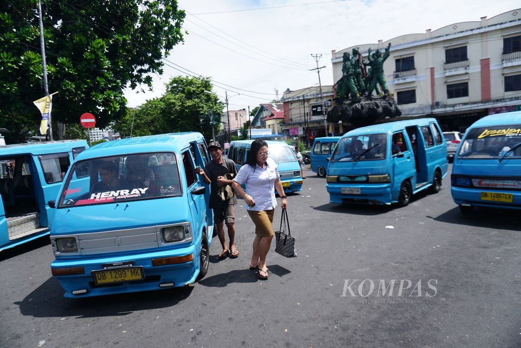Beberapa mikrolet berhenti untuk menurunkan sekaligus menunggu penumpang, Selasa (9/5/2023), di belokan menuju area Pasar 45, Manado, Sulawesi Utara.