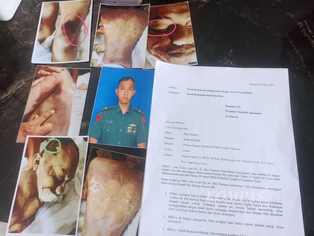 Keluarga menunjukkan foto semasa hidup dan luka lebam jenazah Letnan Satu Dokter Eko Damara, di Medan, Rabu (15/5/2024). Eko disebut meninggal karena bunuh diri dengan menembak sendiri kepalanya. Namun, keluarga mencurigai dugaan pembunuhan karena adanya luka lebam. 